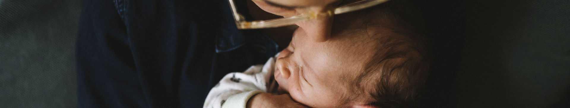 Mamma pussar sin nyfödda bebis på pannan